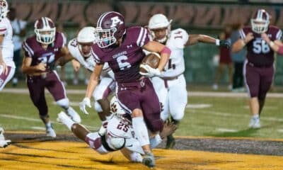 Richard R. Barron | The Ada News -- Ada running back Kaden Gallagher (6) finds some running room as Ardmore defender CJ Williams (25) dives at his feet during their Week 1 matchup Friday night at Norris Field. Gallagher finished with seven rusher for 19 yards in the contest.