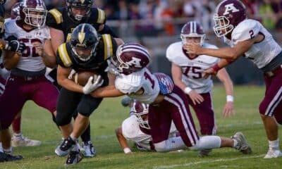 Ada’s George Maddox (19) grabs a Tecumseh runner and gets help from Caden Balthrop (52) and Nate Richardson (2) during a District 4A-2 contest Friday night in Tecumseh. Maddox recorded a team-high 10 tackles in the Ada victory.