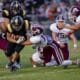 Ada’s George Maddox (19) grabs a Tecumseh runner and gets help from Caden Balthrop (52) and Nate Richardson (2) during a District 4A-2 contest Friday night in Tecumseh. Maddox recorded a team-high 10 tackles in the Ada victory.