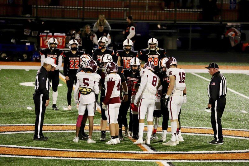Kristi Mitchell | For The Ada News -- Ada senior team captains Jonah Ascencion (5), Hunter Condon (47), Trey Ivy (8) and Brogen Cochran (16) shake hands with Cushing’s team captains during the pregame coin flip before their District 4A-2 matchup Friday at O’Dell Field. Ada hosts Classen SAS on Senior Night at Norris Field Friday in the Cougars’ final game of the 2021 season.