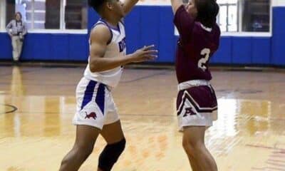 Carizma Nelson | For The Ada News -- Ada junior Cooper Patterson keeps the ball away from the opposition during a Monday afternoon contest with host Durant. The Cougars won 62-52.