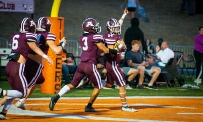 Richard R. Barron | The Ada News -- Ada junior Jagger Caldwell (54) celebrates with some teammates after scoring on a 25-yard fumble return early in the Cougars’ Week 6 matchup with Madill Friday night inside Koi Ishto Stadium. Ada went on to thump the Wildcats 47-14.