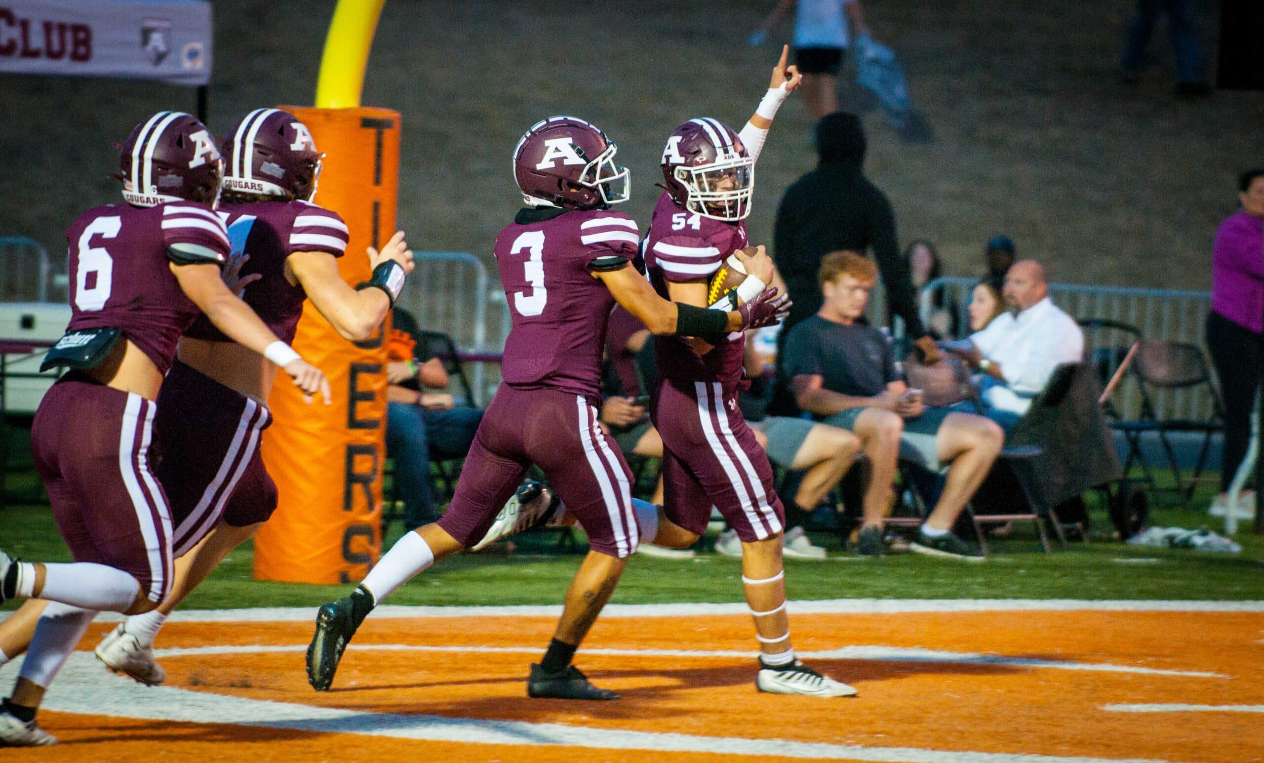 Richard R. Barron | The Ada News -- Ada junior Jagger Caldwell (54) celebrates with some teammates after scoring on a 25-yard fumble return early in the Cougars’ Week 6 matchup with Madill Friday night inside Koi Ishto Stadium. Ada went on to thump the Wildcats 47-14.