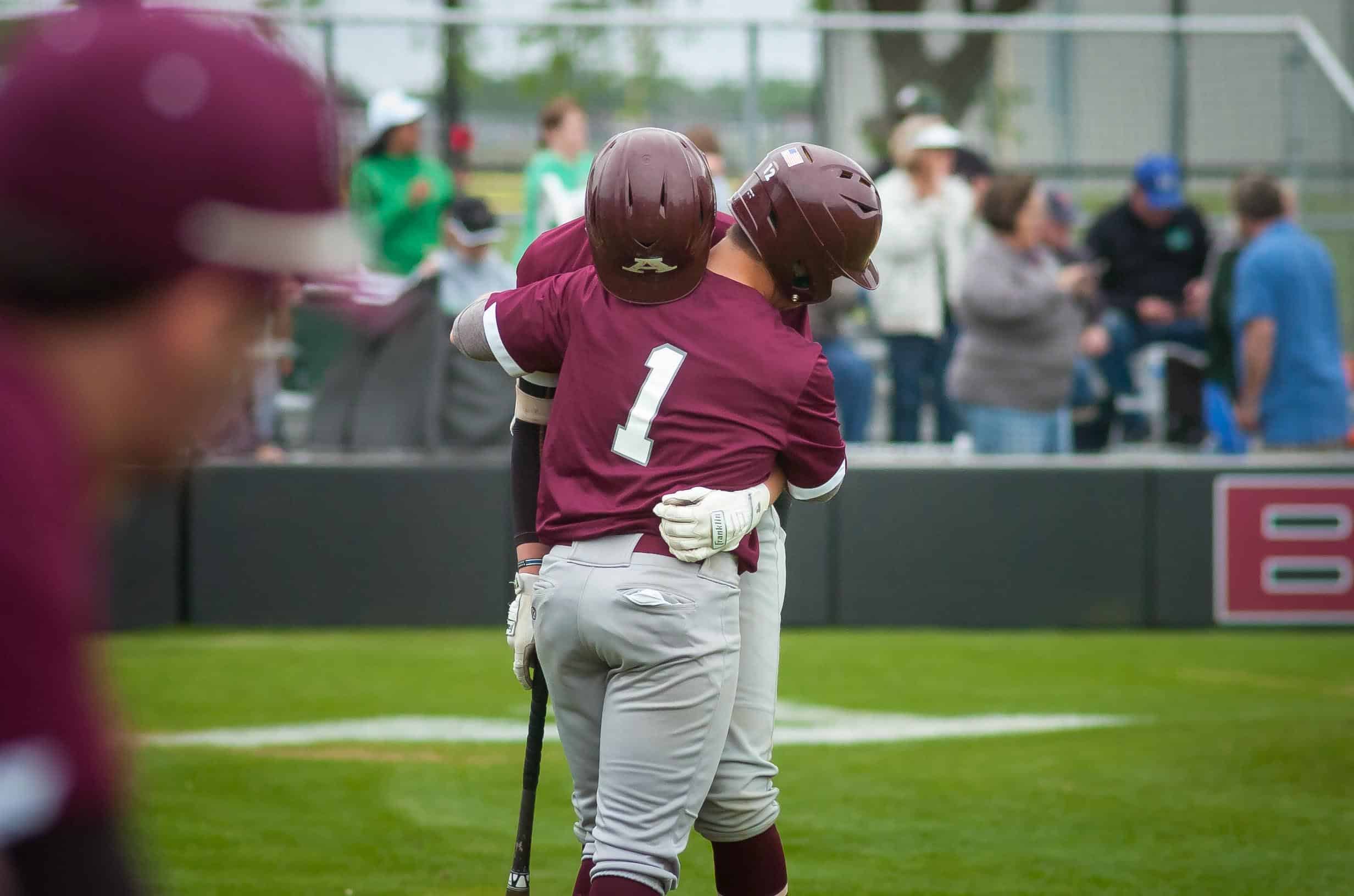 Richard R. Barron | The Ada News -- Ada’s Carter Freeland and Hunter Condon (1) share a hug after the final out was made in the Cougars’ 11-2 loss to Bishop McGuinness Saturday in Game 3 of their best-of-three Class 4A Bi-District series at Cougar Field.