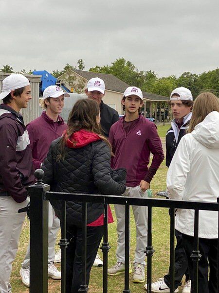 Ada High golfers Derek Layton, David Anderson, David Johnson, Michael Huff and Mack Weems are shown standing around during a weather delay that lasted well over two hours Tuesday at the Class 4A State Tournament hosted by the Winter Creek Golf and Country Club in Blanchard.