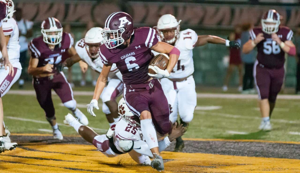 Richard R. Barron | The Ada News -- Ada running back Kaden Gallagher (6) finds some running room as Ardmore defender CJ Williams (25) dives at his feet during their Week 1 matchup Friday night at Norris Field. Gallagher finished with seven rusher for 19 yards in the contest.